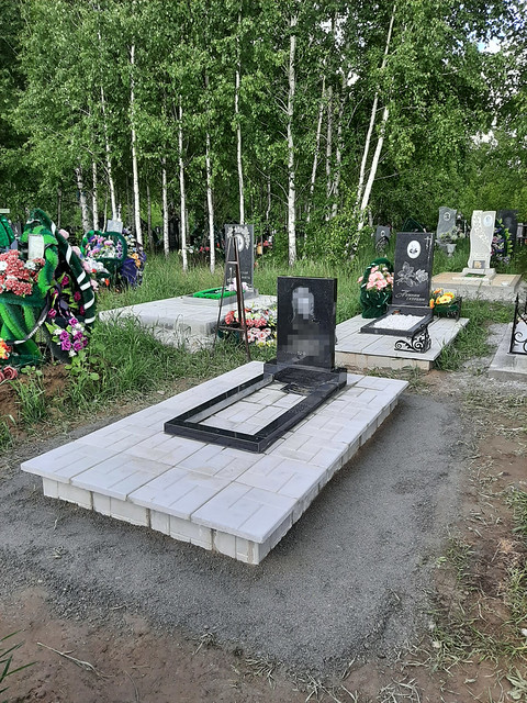 Установленный гранитный памятник на облицованном подиуме